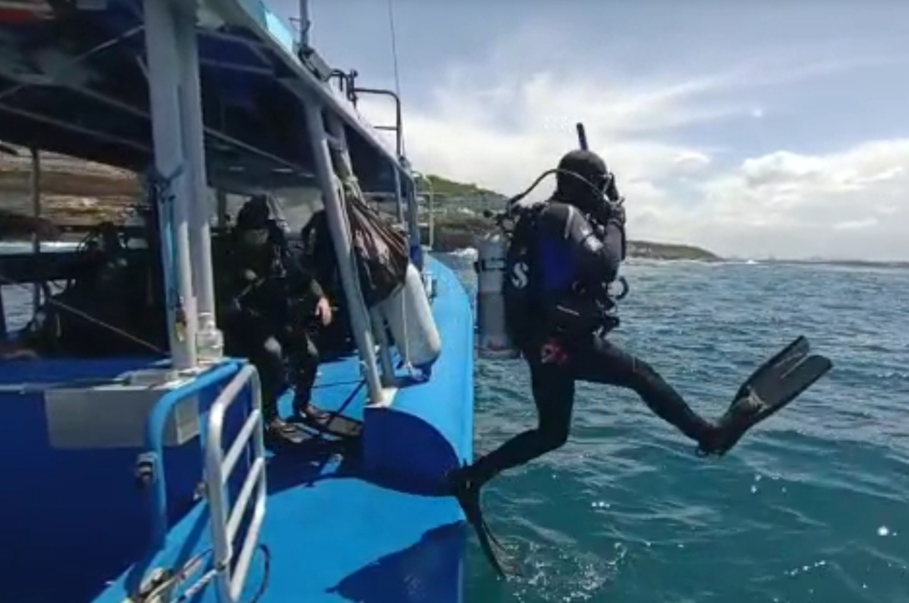 A divers on a double boat dive at Magic Point