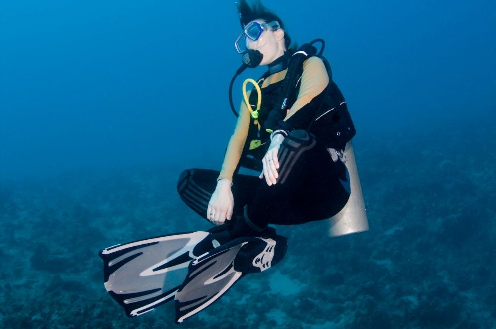 Scuba diver wearing a buoyancy control device and maintaining neutral buoyancy in the underwater world