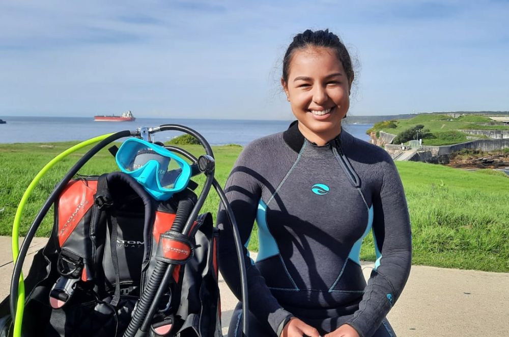 A diver with scuba equipment, ready to explore the underwater world