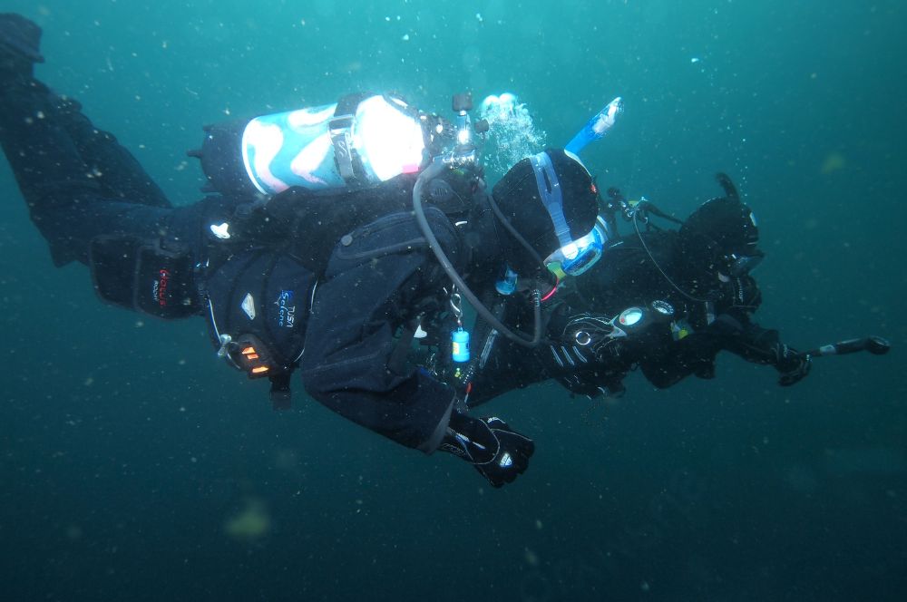 Scuba diver buddies exploring the depths of the ocean