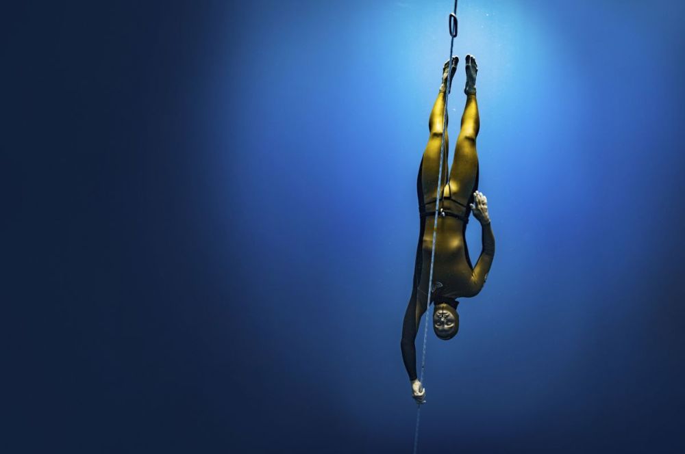 A male freediver attempting a record-breaking deep dive