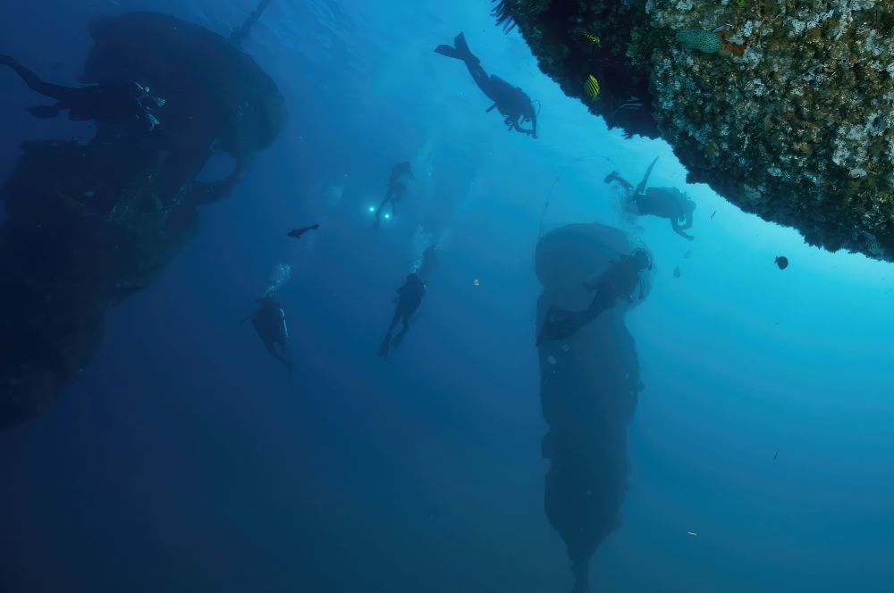 Divers exploring the unique buoyant reef at Wonder Reef