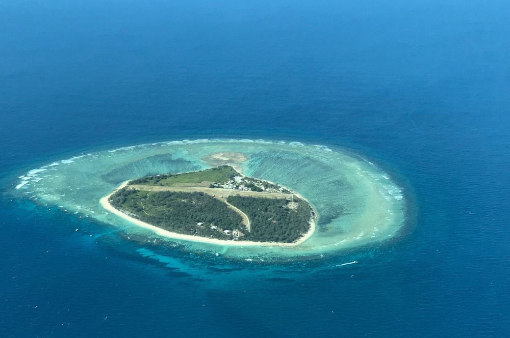 Aerial view of Lady Elliot Island surrounded by turquoise waters and coral reefs