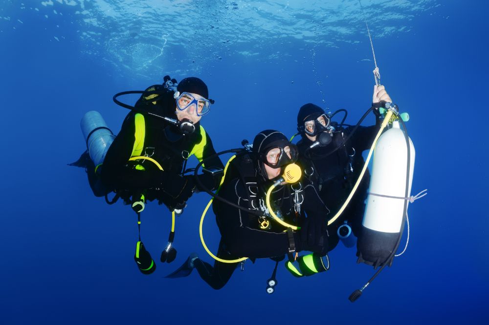 Scuba divers in the ocean, learning new skills