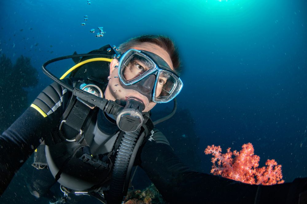 Scuba divers in the ocean, discovering new dive destinations