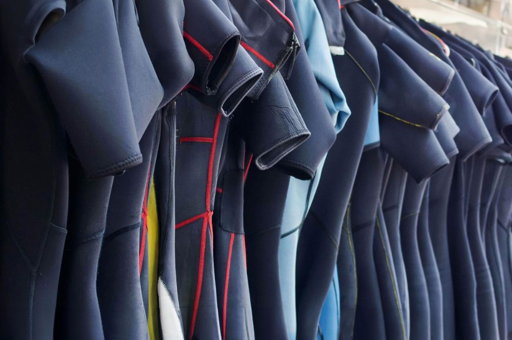 wetsuits haning up to air after washing