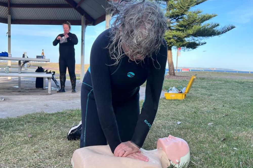 A diver in a wet suit, doing first aid certificate training