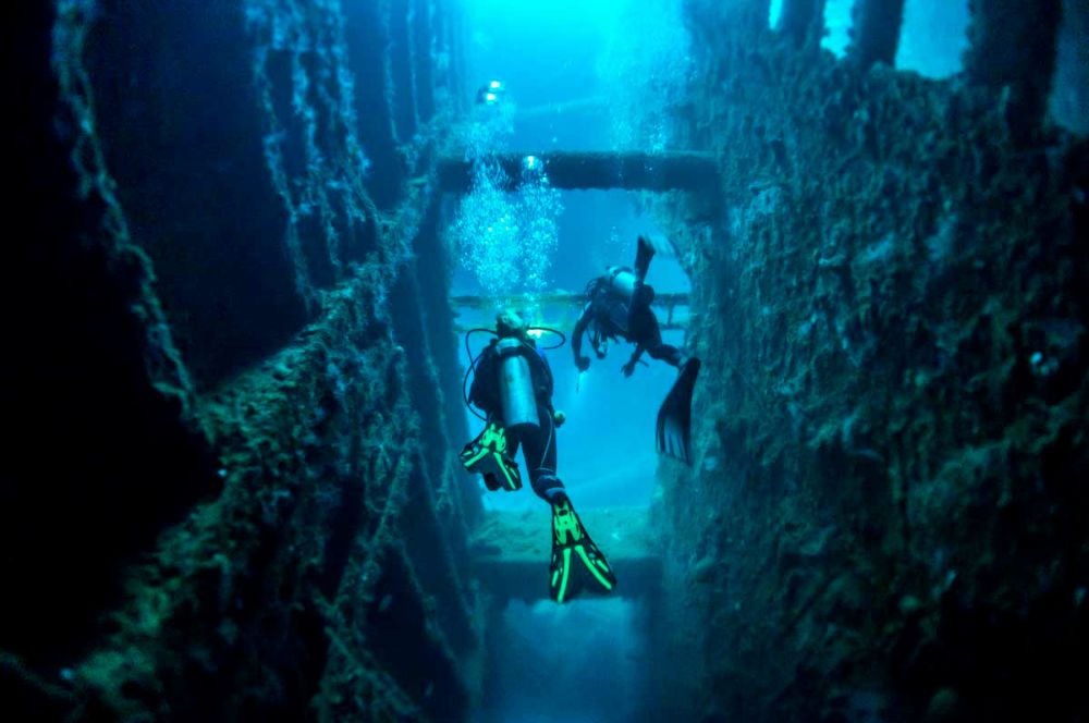 A diver exploring the SS President Coolidge wreck dive site