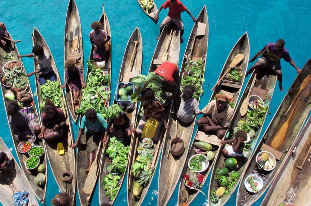 Local canoes suppling food to a liveaboard in the Solomon Islands