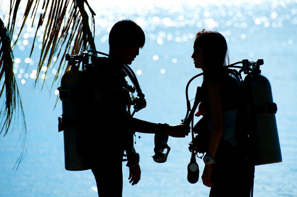 A diver in a scuba diving gear, enjoying the financial benefits of becoming a Divemaster