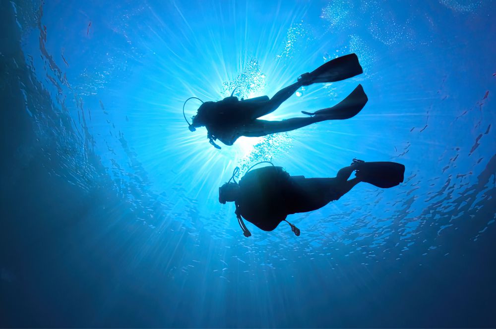 An image of scuba divers following proper safety measures while diving, ensuring scuba diving safety