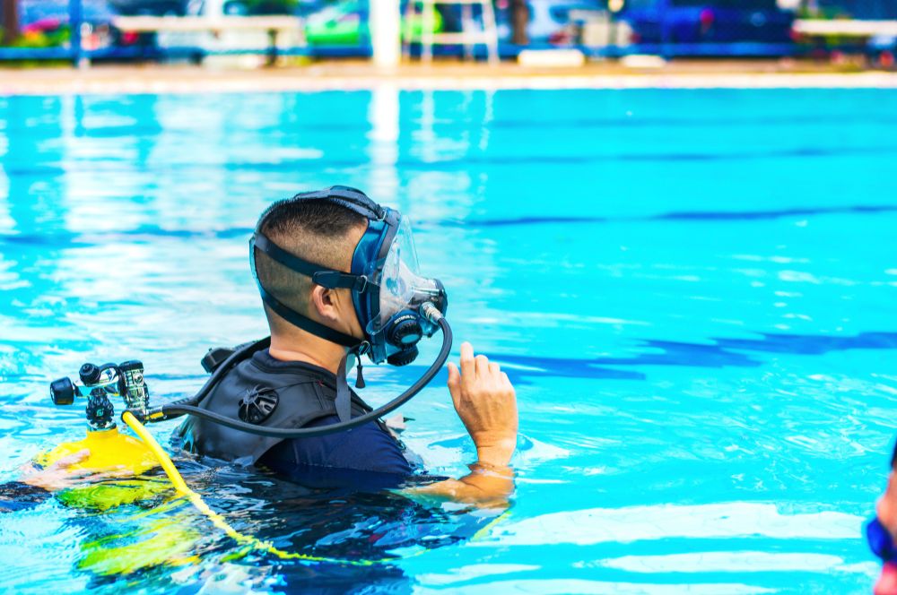 A person wearing a full face dive mask