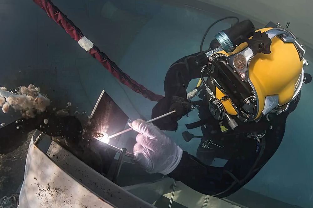 A diver in a wet suit, underwater welding