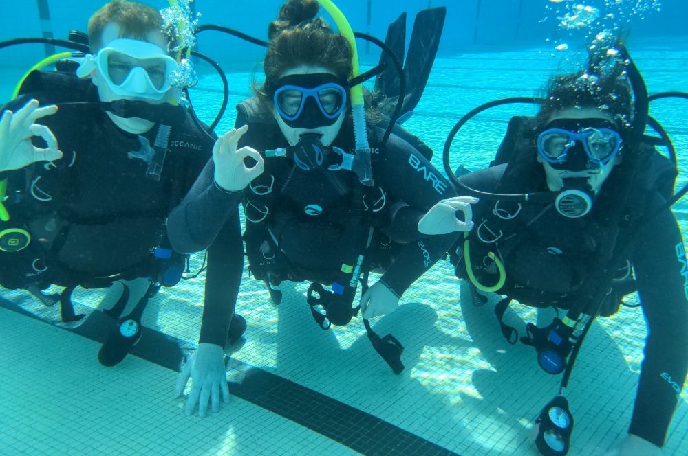 Scuba diver in the swimming pool with scuba gear