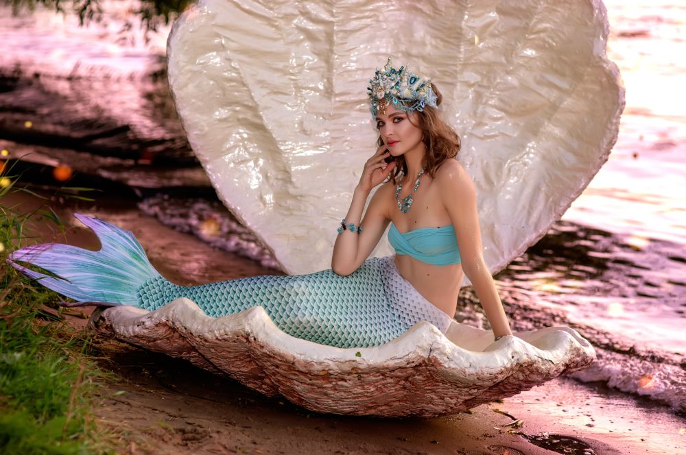 A person wearing a mermaid tail and accessories