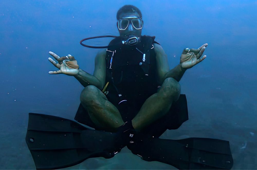 A scuba diver  in a meditative state, calmly floating in the water