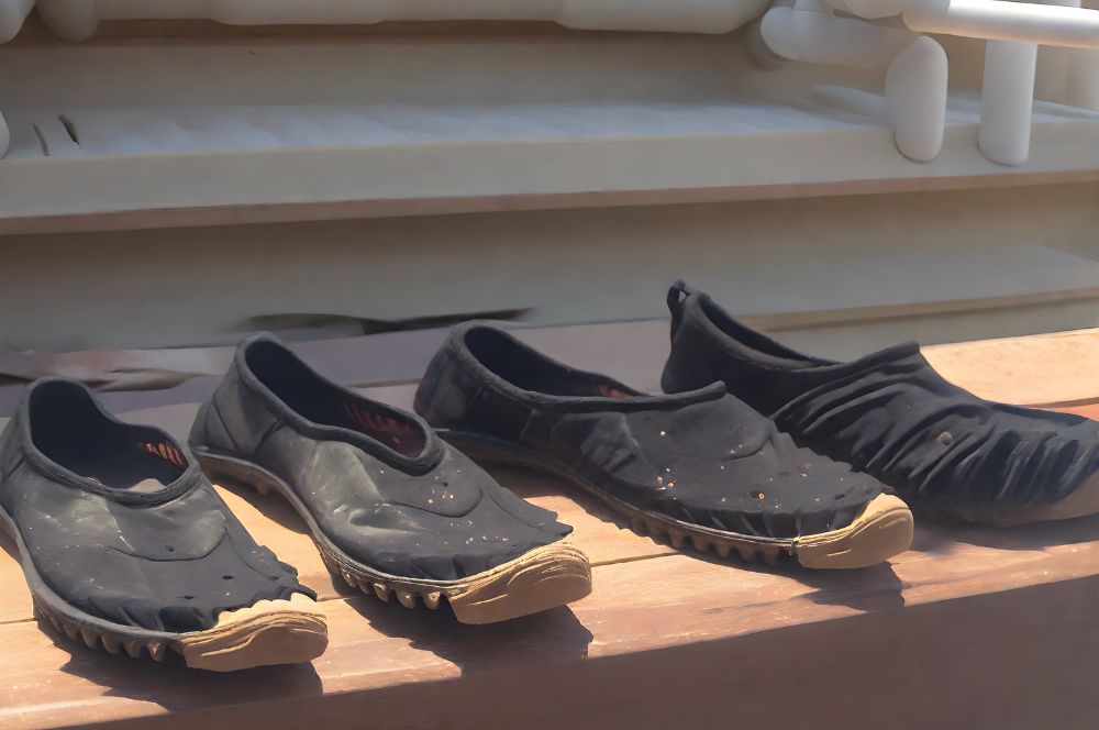 Several pair of reef shoes being air-dried after cleaning