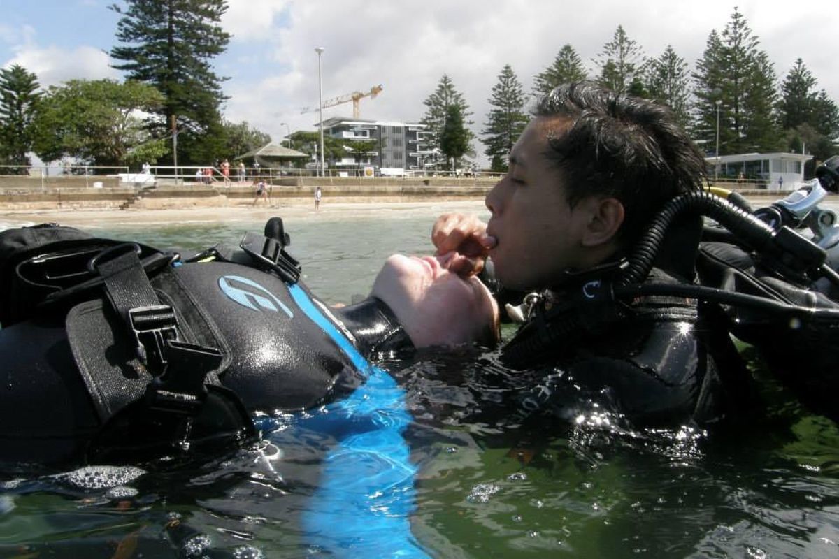 A scuba diver in a potentially dangerous situation, highlighting the question is scuba diving dangerous?