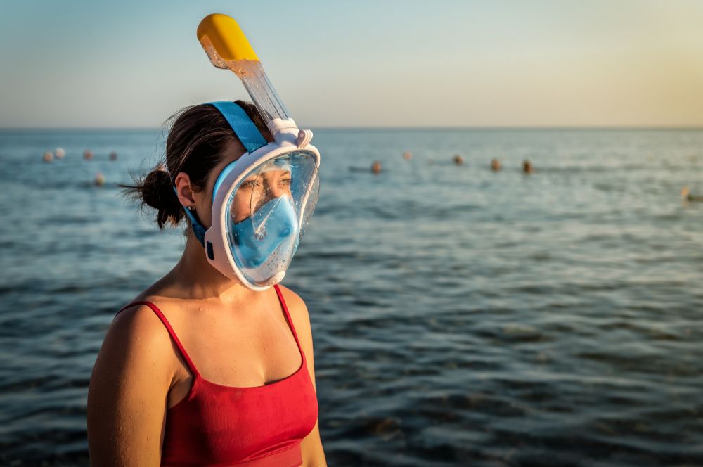 A person using a full face snorkel mask for a comfortable snorkeling experience