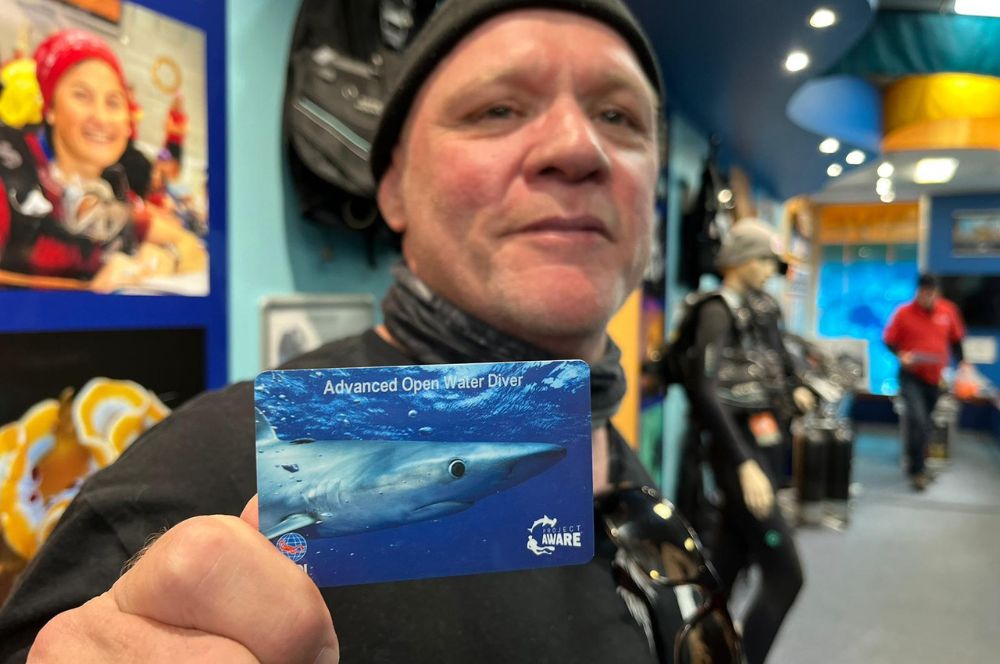 Scuba diver showing his certification card