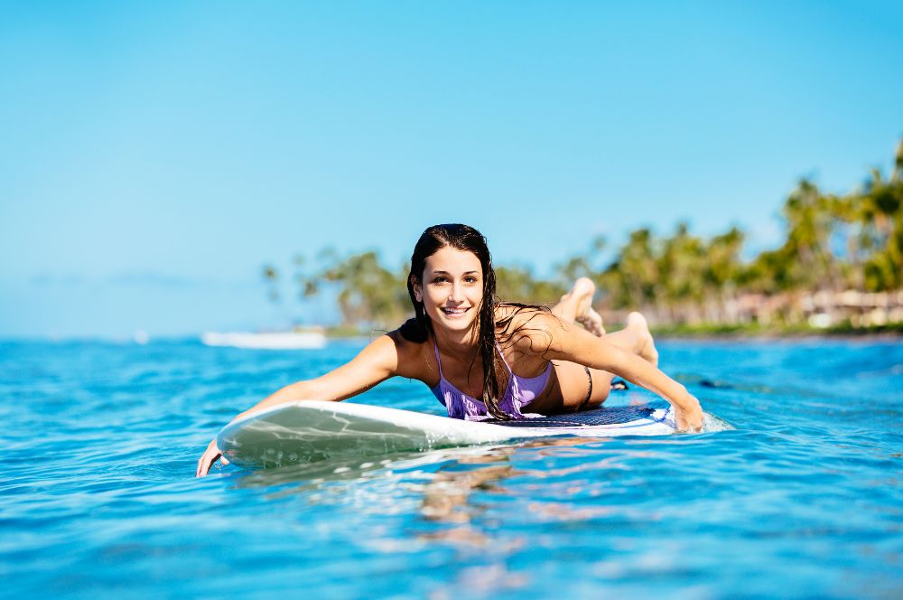 Surfer paddling out to the waves with expertise
